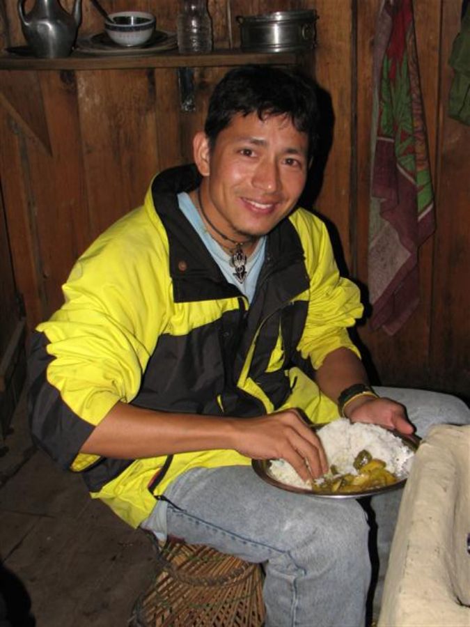 Our porter - guide: Tilak, eating traditional Dal Baht 